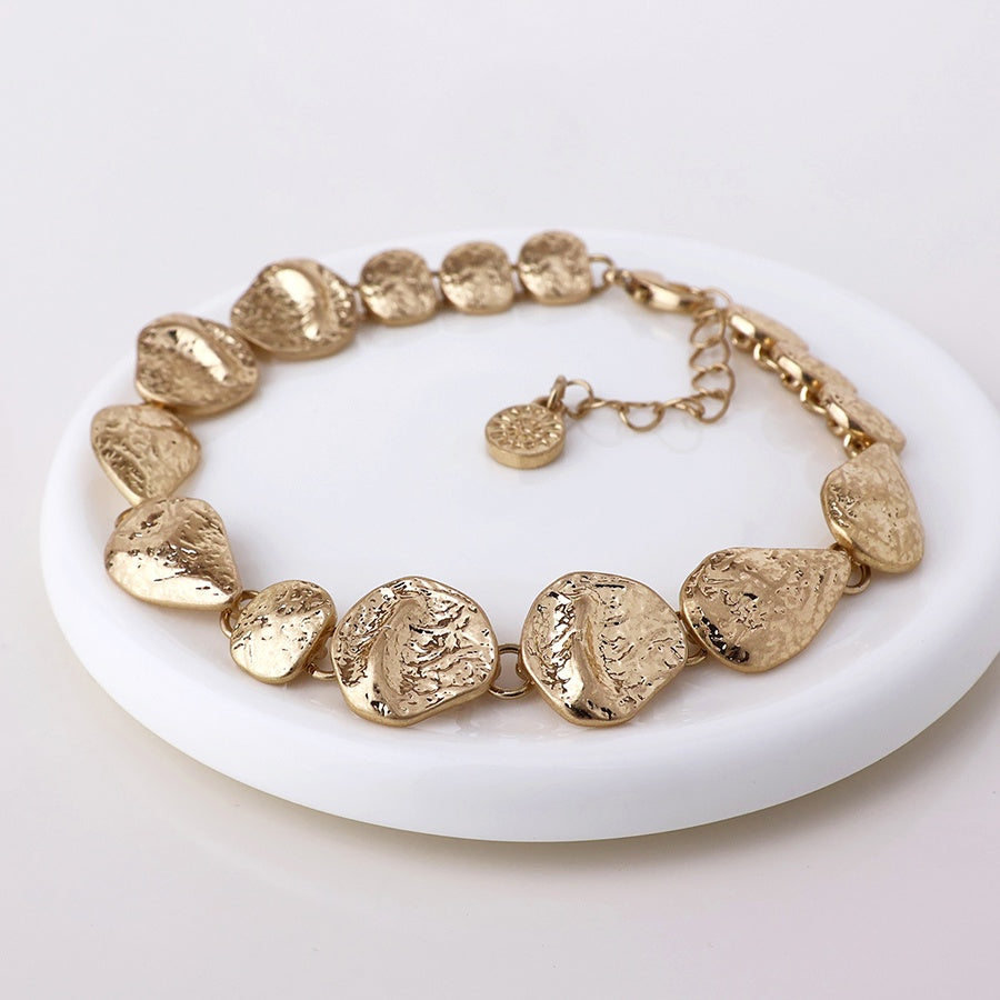Molten bracelet-worn gold