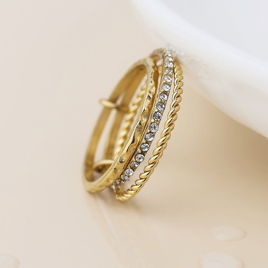 Gold plated stainless steel linked triple ring stack with inset crystals