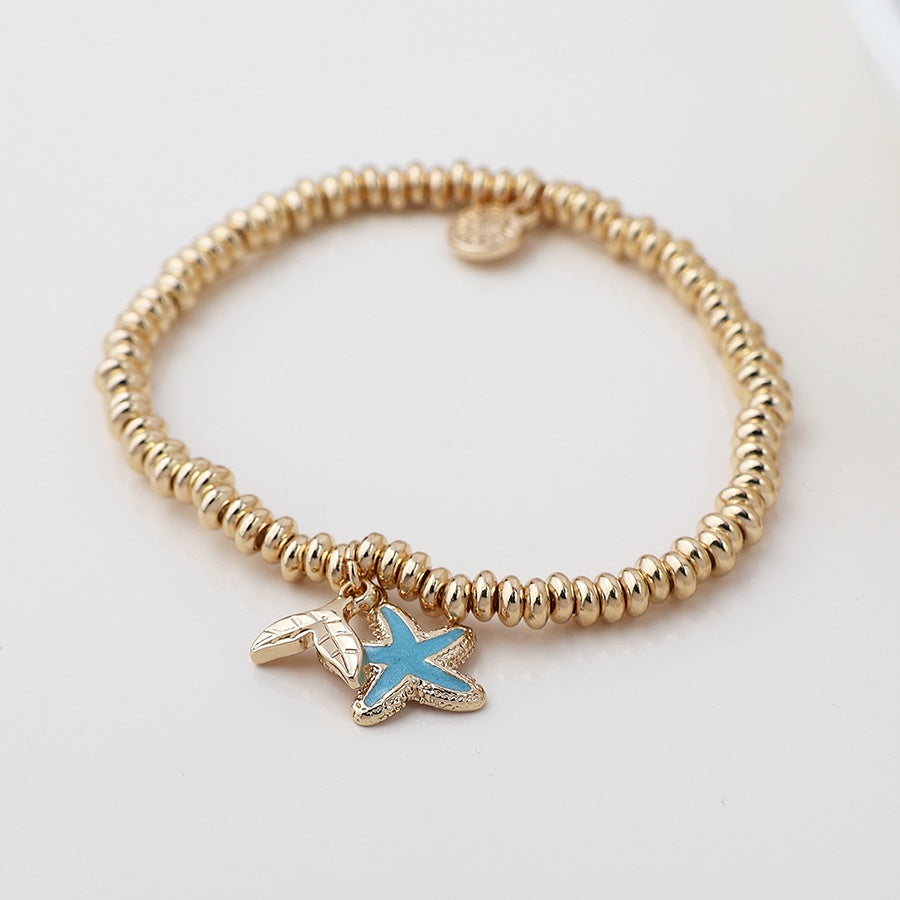 Faux gold bead bracelet with blue enamel starfish charm
