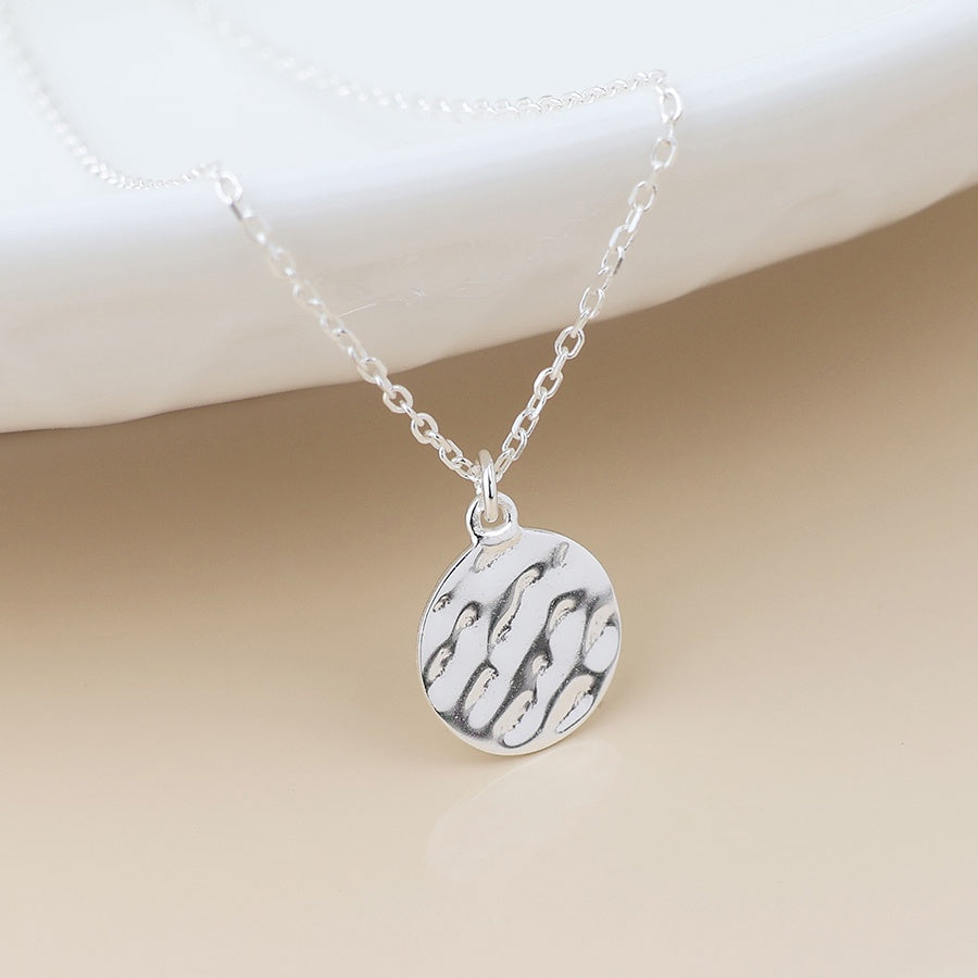 Sterling silver beaten disc pendant necklace